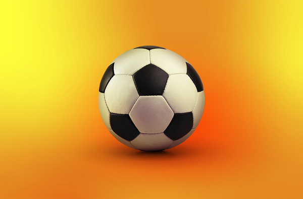 Balón de fútbol soccer con fondo amarillo detrás 